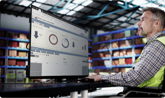 Warehouse operator using CMMS on a monitor